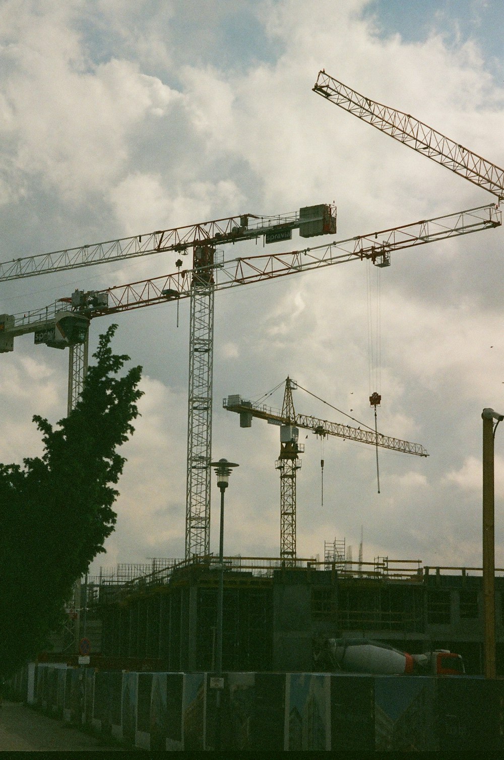 Construction cranes and equipment at a building site.
