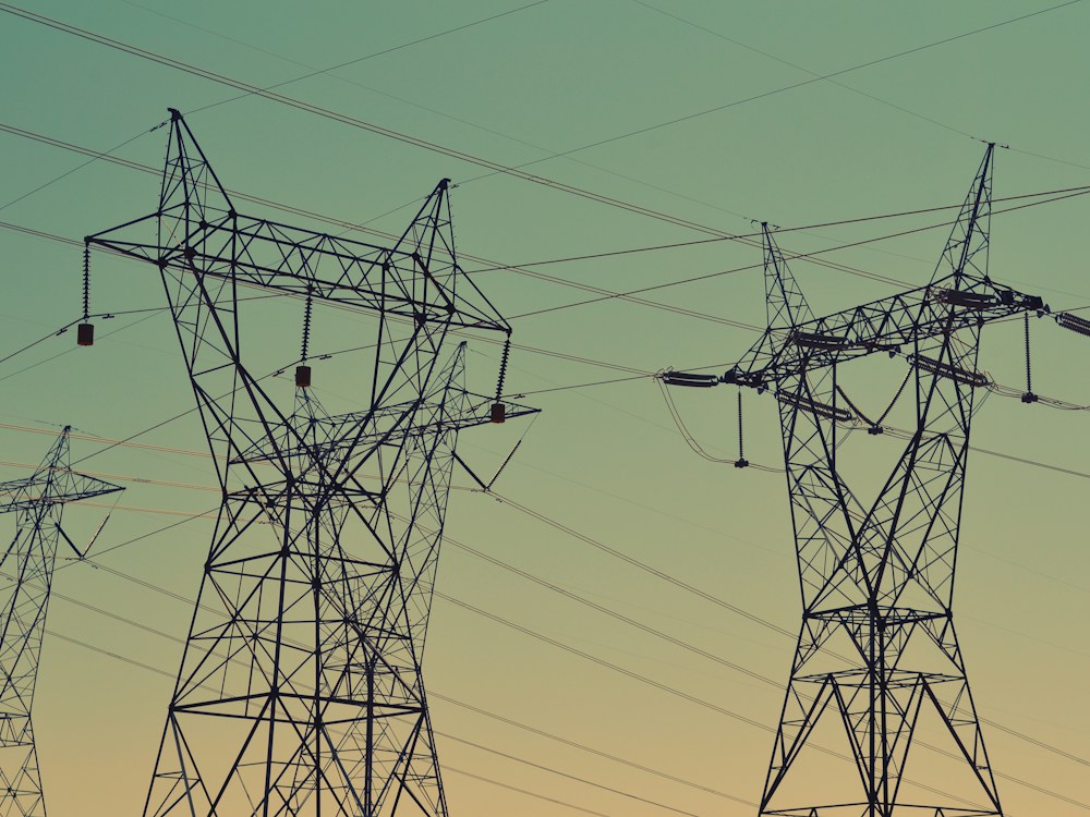 Electricity transmission towers across open fields.